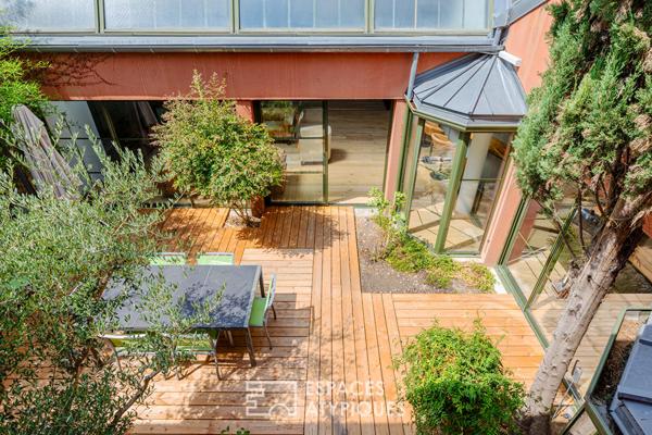 Anciens entrepôts de presse réhabilités en loft de plain pied avec patios