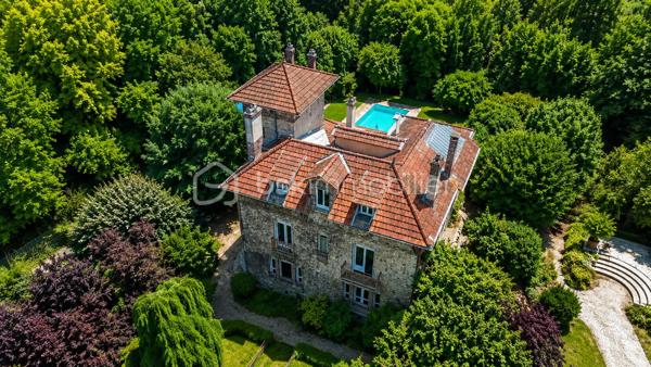 Propriété de prestige en bord de Marne – Une adresse rare aux portes de Paris

Certaines demeures traversent le temps avec une élégance qui ne se démode jamais.

Nichée dans l'un des secteurs les plus recherchés de Lagny-sur-Marne, au fil de l'eau et à seulement 25 minutes de Paris, cette remarquable propriété de caractère datant de 1905 offre un cadre de vie d'une rare distinction.

Édifiée en pierre meulière, emblématique des plus belles résidences bourgeoises franciliennes, la demeure s'élève au cœur d'un parc arboré de plus de 2 100 m².

À l'abri des regards, dans un environnement préservé où seuls le murmure de la Marne et le chant des oiseaux viennent troubler la quiétude des lieux, elle déploie tout le charme et l'authenticité d'un patrimoine d'exception.

Dès le hall de réception, les volumes généreux, les hauteurs sous plafond, les parquets anciens et les cheminées en marbre témoignent du raffinement originel de la propriété. Les espaces de réception, baignés de lumière, offrent près de 50 m² dédiés à la convivialité et à l'art de recevoir.

La cuisine familiale, élégamment aménagée et entièrement équipée, s'ouvre sur le jardin et complète harmonieusement les espaces de vie. Une arrière-cuisine, un vestiaire ainsi que les espaces techniques viennent parfaire le confort quotidien.

Les étages accueillent plusieurs chambres aux dimensions généreuses, dont certaines bénéficient de vues privilégiées sur le parc. Une chambre avec salle d'eau privative, un dressing indépendant, une salle de bains raffinée ainsi qu'un espace lingerie composent un premier niveau pensé pour le confort familial. Une autre chambre bénéficie de son propre atelier d'artiste, véritable invitation à la créativité et à l'inspiration, atelier du célèbre horloger et peintre Léon Hatot.

Sous les toits, un dernier niveau offre une chambre supplémentaire avec salle d'eau privative ainsi qu'un vaste espace de vie pouvant devenir une suite indépendante, un salon privé, une bibliothèque, un bureau de prestige ou un espace dédié au bien-être.

À l'extérieur, le parc révèle toute sa magie. Une élégante terrasse prolonge les espaces de réception vers une piscine parfaitement intégrée dans son environnement paysager. Plus loin, les jardins offrent de vastes perspectives verdoyantes propices à la détente et aux promenades en toute intimité.

Cette propriété unique conjugue avec harmonie le prestige architectural, la douceur de vivre au bord de l'eau et la proximité immédiate des commodités, des établissements scolaires réputés et des accès rapides vers Paris.

Une demeure confidentielle et intemporelle destinée à une clientèle en quête d'élégance, de discrétion et d'un art de vivre exceptionnel.

**Une propriété rare. Une adresse privilégiée. Un patrimoine d'exception.**

** Un terrain de 2125m² avec plusieurs possibilités.**