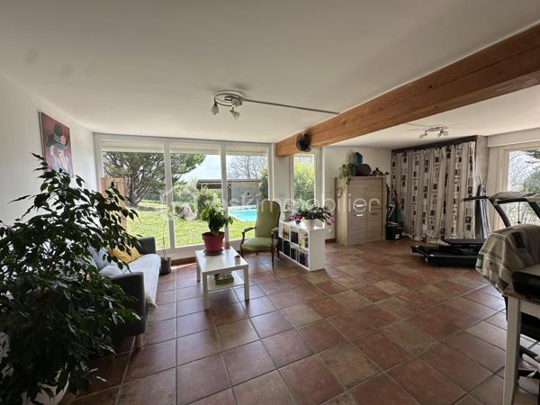 Anna Morra vous propose à la vente, sur la commune de Gimont, cette magnifique maison de style chalet, entièrement rénovée avec goût en 2024. 
Nichée dans un écrin de verdure, au calme, elle offre une vue dégagée sur les Pyrénées tout en restant à quelques minutes en voiture des commodités.

Dès l’entrée, vous serez séduit par une vaste pièce de vie de 58 m², baignée de lumière grâce à ses grandes ouvertures sur la nature environnante. Son plafond cathédrale, ses poutres apparentes et sa cheminée en pierre avec insert créent une atmosphère chaleureuse et conviviale. Une mezzanine surplombe cet espace, idéale pour un coin lecture, un bureau ou une chambre d’appoint. La cuisine semi-ouverte, aménagée et équipée, allie fonctionnalité et modernité.

Attenante à la pièce de vie, une grande salle de 32 m² avec vue sur la piscine offre de nombreuses possibilités d’aménagement : bureau, salle de jeux, salon TV ou salle de sport. Depuis cette pièce, un escalier mène à une chambre de 12,9 m² bénéficiant d’une terrasse privative de 11,5 m², offrant un espace indépendant et privilégié.

Sur le côté droit de l’entrée, un WC avec lave-mains ainsi qu’une buanderie avec accès direct sur l’extérieur apportent une fonctionnalité supplémentaire avant d’accéder au coin nuit, pensé pour garantir intimité et confort.

L’espace nuit s’organise autour de deux dégagements distincts. Le premier mène à une grande chambre de 17,8 m² avec placards intégrés, située à proximité de la salle de bains principale, véritable espace bien-être avec douche à l’italienne, baignoire et finitions en travertin. Le second dessert deux autres chambres avec accès direct à l’extérieur : une chambre de 13,6 m² avec petit dressing et une chambre de 15,3 m² avec salle d’eau privative comprenant douche à l’italienne, double vasque et WC.

À l’extérieur, le terrain vallonné de 12 129 m² alterne espaces dégagés et boisés, offrant un cadre idéal pour les amoureux de la nature. Il n’est pas rare d’y apercevoir chevreuils et lapins. Une piscine de 10,05 x 4,10 m avec pente douce (de 1,05 m à 1,90 m) et son pool-house permettent de profiter pleinement des beaux jours en famille ou entre amis.

Cette propriété dispose également de nombreux atouts : grandes ouvertures offrant une luminosité exceptionnelle, chaudière à granulés installée en 2019, panneaux solaires mis en service en mai 2023 permettant l’autoconsommation et la revente d’électricité, double garage en sous-sol, cave et local chaufferie.

 Un bien rare sur le secteur, alliant charme, confort et nature dans un environnement privilégié. À découvrir sans tarder !

 Contactez moi pour plus d’informations ou organiser une visite au 06 11 32 63 44