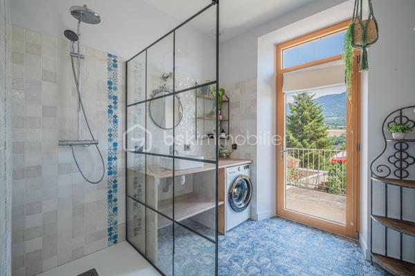 À seulement quelques minutes d'Aix-les-Bains, découvrez cette bâtisse de caractère entièrement rénovée, où le charme de la pierre s'allie au confort d'aujourd'hui.
Située dans un environnement calme, à proximité immédiate de la forêt de Corsuet, elle offre un cadre de vie privilégié entre nature et ville, avec une belle vue dégagée sur le Revard, la Dent du Chat et les montagnes environnantes.

Dès l'entrée, les volumes généreux, les grandes ouvertures et les matériaux authentiques révèlent toute la personnalité de cette maison. Les murs en pierre, les parquets massifs et les belles hauteurs sous plafond confèrent à la maison une atmosphère chaleureuse et authentique.
La maison développe environ 110 m² habitables. Le rez-de-chaussée accueille une vaste pièce de vie d'environ 40 m² avec cuisine ouverte entièrement équipée, une chambre avec salle d'eau privative ainsi qu'un WC indépendant, permettant une vie de plain-pied.

À l'étage, deux belles chambres, une seconde salle d'eau moderne et un WC indépendant composent un espace nuit confortable et fonctionnel.
Entièrement rénovée avec soin, la maison est prête à accueillir ses futurs propriétaires sans travaux importants. Ses épais murs en pierre offrent également un confort très appréciable en été, en conservant naturellement une agréable fraîcheur, même lors des fortes chaleurs.

À l'extérieur, le jardin et les terrasses ombragées invitent à profiter pleinement du cadre environnant et de la vue sur les montagnes. Un carport ainsi que plusieurs places de stationnement complètent les prestations.
Une superbe cave voûtée d'environ 35 m² ainsi que 77 m² de combles aménageables viennent compléter ce bien et offrent un véritable potentiel d'évolution selon vos envies.

À quelques pas des sentiers de randonnée et de VTT de la forêt de Corsuet, et à seulement quelques minutes des commerces, des écoles, du lac du Bourget et des accès autoroutiers, cette maison offre un équilibre rare entre authenticité, confort et qualité de vie.

Ce que vous allez apprécier :
✔ Maison entièrement rénovée, prête à vivre de plain-pied
✔ Pièce de vie de 40 m² + 2 salles d'eau
✔ Cave voûtée de 35 m²
✔ 77 m² de combles aménageables
✔ Vue dégagée sur les montagnes
✔ Fraîcheur naturelle en été grâce aux murs en pierre
✔ Forêt de Corsuet à proximité immédiate
✔ DPE C

Un lieu de vie avant tout
Plus qu'une maison, c'est un lieu de vie. Ici, on profite de la nature sans s'éloigner de la ville, des soirées sur la terrasse face aux montagnes, de la fraîcheur des murs en pierre durant l'été et des départs à pied vers la forêt de Corsuet.
Authentique, chaleureuse et soigneusement rénovée, cette maison séduira celles et ceux qui recherchent autant une qualité de vie qu'un bien de caractère.

Pour plus d'informations ou pour organiser une visite, contactez-moi. Une vidéo de présentation est également disponible sur demande.