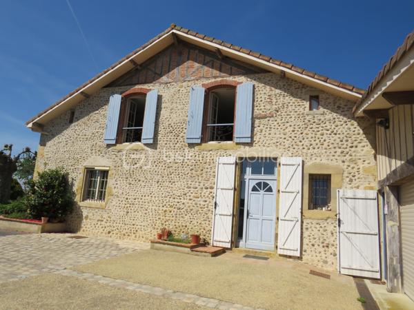 (Dép.40 LANDES) Ancien presbytère en galets de l' Adour entièrement rénové avec gout et matériaux de qualité entre Aire-sur-l’Adour et Garlin.
Situé dans un environnement paisible face aux Pyrénées, cet ancien presbytère datant de 1900 saura vous séduire par ses beaux volumes, ses murs épais en galets de l'Adour et ses poutres apparentes qui allient le charme de l'ancien et le confort moderne.

Exposée plein sud, la maison se distingue par ses murs épais et son entretien irréprochable.
Elle se compose en Rez de Chaussée d'une belle entrée qui donne le ton avec une cuisine entièrement équipée ouverte sur le salon (ensemble de 80 m²) très lumineux avec accès sur la terrasse, une suite parentale de 28 m² (salle d'eau avec douche italienne, WC et dressing), un grand cellier buanderie et un second WC aux normes PMR.
A l'étage, un palier dessert deux grandes suites parentales de 25 m² et 26 m² (salle d’eau et WC privatifs) et une troisième chambre de 33 m² avec WC  qui en fait un bel espace pour une salle de jeux ou un espace nuit supplémentaire selon vos besoins.

Coté technique, tout y est avec un chauffage par PAC Air/eau (installation récente et sous garantie), une PAC Air/Air (climatisation réversible en RDC), un poêle à bois (14 KW) et une très belle cheminée à foyer ouvert dans le salon, eau chaude sanitaire branchée sur la PAC, fenêtres PVC double vitrage, fibre en place, combles isolés et alarme. Des panneaux solaires de 3 KW sont en place pour l'auto consommation, portes de garages et portail d'entrée à ouverture par commandes électriques.
Très bon DPE gratifié de la lettre C qui témoigne de son efficacité énergétique.

Un garage double avec dépendance, cave et local de chaudière de près de 90 m² complètent ces prestations.
Le terrain propice à la détente de près de 3000 m² clos et arboré avec sa terrasse, places de parking, chenil, terrain de pétanque et un puits sont à disposition.

Cette propriété bénéficie d'un environnement calme et reposant, tout en étant à seulement quelques minutes des commerces et services d'Aire sur Adour et de Garlin.

De plus, l'océan et les montagnes sont accessibles en moins de 1H30 de route, pour un parfait équilibre entre tranquillité et accessibilité.
Accès autoroute A65 à 5 kms et Aéroport de PAU à 30 min

Un véritable coup de cœur pour les amoureux de la campagne, de la vieille pierre et de l'authenticité landaise.

Alors prêt pour une visite !!!!!
Contacter Frédéric (BSK Immobilier) pour vous organiser cela.