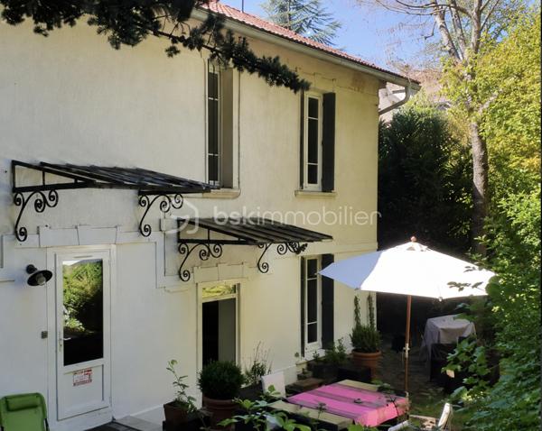 Sur un terrain boisé de 3000 mètres, sans vis-à-vis, cette maison de 1901 se dresse dans la partie haute, avec une magnifique verrière d'époque sur les deux étages, véritable poumon lumineux de la maison.
L'entrée se fait dans la verrière et dès ce moment vous êtes saisi par l'ambiance chaleureuse de cette maison, grâce à une alliance parfaite entre l'ancien et le moderne.
La salle à manger arrive ensuite au centre de la maison avec son joli carrelage d'origine en carreaux de ciment dans les tons de bleu. Les autres pièces du rez-de-chaussée s'articulent autour de cette pièce de vie :
A sa gauche, avec une jolie fenêtre arrondie, une belle pièce, salon lecture et TV qui peut être transformée en chambre.
Juste derrière, un espace WC séparé, puis salle de douche, et ensuite la grande cuisine refaite récemment et très fonctionnelle. Elle ouvre sur l'arrière de la maison pour accéder à la terrasse ombragée.
A droite de la salle à manger, avec une grande ouverture, un salon traversant qui totalise toute la partie droite de la maison au rez-de-chaussée. Ses deux fenêtres, son joli plancher et sa cheminée en font un endroit idéal pour s'installer avec ses amis autour d'un apéritif.
Nous passons maintenant à l'étage, l'escalier nous amène à l'entrée d'une grande pièce centrale au plancher blanc qui dessert, une salle lumineuse dans la véranda, 4 grandes chambres, une salle de bain et des WC séparés.
Au dessus des combles non aménagés.
Au sous sol, un espace de 100 m2, comprenant chaufferie, grande lingerie et cave à vins.
Sur la partie basse du terrain un portail pour accéder en voiture et un garage double.
L'ensemble est chauffé de façon économique et éco-responsable par une pompe à chaleur.
Le DPE est en D et les fenêtres en PVC sont en double vitrage.
La taxe foncière est de 3000€/an.
Un ensemble immobilier incroyable qualifié souvent de "château" et qui est une Maison de Maître du siècle dernier !