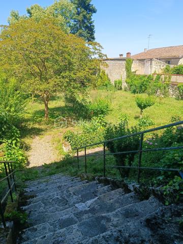Lectoure séduit par son patrimoine historique, ses thermes réputés, sa vie culturelle dynamique et sa douceur de vivre unique au cœur du Gers.

À quelques pas des commerces, restaurants, écoles, services et du célèbre marché de la ville, cette remarquable demeure de caractère a tout pour devenir une véritable maison de rêve à Lectoure.

Cette maison de ville aux volumes exceptionnels offre de belles hauteurs sous plafond et de nombreux éléments anciens soigneusement préservés : parquets d’époque, moulures, cheminées anciennes…

Traversante sud/nord, la maison bénéficie d’une luminosité remarquable tout au long de la journée. Son grand jardin, avec de superbes vues dégagées sur la campagne, ainsi que sa localisation idéale, en font un bien rare.

Au rez-de-chaussée, une vaste entrée distribue plusieurs pièces aux multiples possibilités d’aménagement : création d’un grand salon de réception, d’une cuisine familiale, accès direct au garage… Un magnifique escalier en pierre mène au jardin.

Depuis l’intérieur, on accède également à la cave, où il serait tout à fait envisageable d’aménager une cuisine d’été ouvrant directement sur le jardin.

Le premier étage accueille de nombreuses pièces de vie laissant libre cours à l’imagination selon vos envies et votre projet. Ce niveau comprend six pièces au total, dont une ancienne cuisine et une salle de bain.

Au deuxième étage, vous trouverez encore cinq chambres ainsi qu’une salle d’eau.

Les menuiseries anciennes en bois ont été conservées et équipées de double vitrage. Les volets peints sont en très bon état, tandis que les sols ont été poncés et laissés bruts, prêts à accueillir votre projet de décoration.

Véritable page blanche pleine de caractère, cette propriété offre un potentiel exceptionnel pour donner vie à un projet familial, artistique, professionnel — ou à une combinaison de tous ces univers. Ses volumes généreux et son charme authentique permettent d’imaginer de nombreuses possibilités.