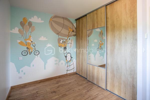 Dans un environnement paisible, au fond d’une impasse, découvrez cette maison individuelle construite en 2015, pensée pour offrir à toute la famille un quotidien serein, confortable et facile à vivre.

Dès l’entrée, la sensation d’espace et de luminosité s’impose naturellement. Exposée plein sud, la pièce de vie de 42 m² constitue le cœur de la maison. Ouverte sur la cuisine aménagée et tournée vers le jardin, elle invite aux moments de partage, des petits-déjeuners en famille aux soirées entre amis, dans une atmosphère chaleureuse et conviviale.

Le rez-de-chaussée est complété par un cellier avec point d’eau ainsi qu’un WC indépendant, apportant un confort appréciable au quotidien.
À l’étage, chacun dispose de son espace avec trois chambres équipées de dressings intégrés et une salle de bains avec baignoire et WC, idéale pour répondre aux besoins d’une vie de famille.

À l’extérieur, le terrain clos de 595 m² devient un véritable prolongement de la maison. Pendant que les enfants profitent du jardin en toute sécurité, les parents savourent les beaux jours sur la terrasse en bois ou autour de la piscine au sel chauffée. Potager et espaces de rangement complètent cet extérieur soigneusement aménagé pour conjuguer plaisir et praticité.

La maison bénéficie également d’équipements recherchés : menuiseries PVC double vitrage, poêle à granulés pour une ambiance chaleureuse en hiver, chauffage électrique et carport double de 27 m² pouvant être transformé en garage fermé selon vos projets.

Son emplacement est un atout majeur. Écoles, collège et commerces sont accessibles à pied, permettant aux enfants de gagner en autonomie et aux parents de simplifier leur organisation quotidienne.
Parfaitement entretenue et ne nécessitant aucun travaux, cette maison vous permet de vous installer immédiatement et de profiter pleinement de chaque instant.
Un bien rare qui réunit les critères les plus recherchés : calme, fonctionnalité, luminosité, extérieur soigné et proximité des commodités. Un lieu de vie idéal pour construire de nouveaux souvenirs en famille.