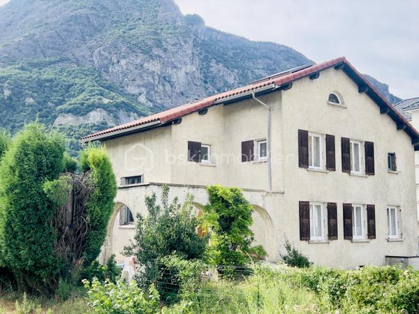 À saisir – Immeuble de rapport à fort rendement – Saint-Jean-de-Maurienne
Découvrez cet immeuble de rapport entièrement rénové de 146 m² habitables (355 m² au sol), idéalement situé à Saint-Jean-de-Maurienne, à proximité des cols et des stations de ski de la Maurienne, dans un secteur particulièrement recherché.
Édifié sur un terrain de 573 m², cet immeuble se compose de deux appartements de type T2, d'un studio et d'un local commercial de 38 m², avec possibilité de le transformer en appartement T2.
Il génère actuellement 60 000 € de revenus locatifs par an (bilan comptable disponible) et offre une rentabilité immédiate de 12 %. Son emplacement privilégié, la forte demande locative et la qualité de sa rénovation en font un investissement sûr et pérenne.
Au rez-de-chaussée :
Un hall d'entrée desservant un local commercial de 38 m², composé de deux pièces et d'une salle d'eau, avec possibilité de transformation en appartement T2.
Un studio de 31 m², conforme aux normes PMR, composé d'un coin nuit, d'un espace cuisine ouvert sur le séjour et d'une salle d'eau avec WC. 
Fonctionnel et accessible, ce logement est parfaitement adapté à tous les profils de locataires. 
À l'étage :
Deux appartements de type T2 de 32 m² chacun, composés d'une cuisine équipée ouverte sur le séjour, d'une chambre confortable et d'une salle d'eau avec WC.
Les trois appartements, les parties communes ainsi que le local commercial ont été entièrement rénovés avec des prestations de qualité. 
Chaque logement est équipé d'une pompe à chaleur réversible, tandis que le local commercial bénéficie également d'un chauffe-eau solaire. 
Les combles, d'une superficie de 50 m² (loi Carrez), sont aménageables et offrent un beau potentiel pour la création d'un logement supplémentaire.
Le sous-sol, d'une superficie de 95 m², comprend trois caves avec buanderie et une chaufferie.
À l'extérieur, plusieurs places de stationnement sécurisées, avec borne de recharge pour véhicule électrique, offrant un confort supplémentaire au quotidien, accessibles par un portail motorisé, viennent compléter ce bien.
Cet immeuble constitue une opportunité rare pour un investisseur à la recherche d'un bien clé en main, offrant une excellente rentabilité, un fort potentiel d'évolution et un emplacement stratégique dans une commune dynamique de la vallée de la Maurienne.