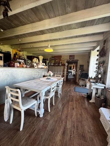 Bien sûr. Voici une version plus fluide, dynamique et attractive, tout en conservant le charme et les caractéristiques importantes du bien :

# Belle charentaise en pierres – 195 m² habitables, jardin arboré et dépendances

**À seulement 5 km de Ruffec et à 3 minutes de la N10**, cette authentique maison charentaise en pierres vous séduira par son charme, ses volumes et ses nombreux éléments anciens préservés. Un emplacement idéal pour profiter du calme de la campagne tout en restant à proximité des commodités, avec **Angoulême accessible en environ 35 minutes**.

D’une superficie d’environ **195 m² habitables**, la maison offre de beaux espaces de vie, lumineux et chaleureux.

### Une maison pleine de caractère

Dès l’entrée, vous découvrirez une **spacieuse cuisine ouverte sur la salle à manger**, idéale pour partager des moments conviviaux. Le salon, chaleureux et authentique, bénéficie d’une **belle cheminée** et d’un superbe sol traditionnel en **« cœurs de demoiselles »**, véritable signature du charme charentais.

À l’étage, l’espace nuit comprend **trois chambres de 11, 11 et 12 m²**, ainsi qu’une **salle de bains moderne** équipée d’une douche et d’une baignoire.

Une seconde partie de la maison offre un espace particulièrement lumineux grâce à ses nombreuses ouvertures sur le jardin. Il peut être aménagé selon vos envies en **salon, bureau, espace de réception ou salle de loisirs**.

Une **mezzanine composée de deux espaces**, dont une **chambre de 16 m² avec point d’eau**, vient compléter cet ensemble et offre encore de belles possibilités d’aménagement.

La maison dispose également d’une **arrière-cuisine avec espace buanderie** ainsi que d’une **chaufferie**, ou il sera très facile d'aménager un espace salle d'eau supplémentaire si besoin 

### Un extérieur qui invite à profiter de la nature

Implantée sur une agréable parcelle de **1 433 m²**, la propriété bénéficie d’un jardin arboré et fleuri agrémenté de **nombreux arbres fruitiers**.

Vous profiterez également d’un **four à pain traditionnel fonctionnel**, d’une **grange** et d’un **atelier**, autant d'espaces qui pourront répondre aux besoins d'une famille, d'un artisan ou d'un projet personnel.

Un **puits** vient compléter les nombreux atouts de cette propriété.

### Les atouts

* Environ **195 m² habitables**
* Terrain arboré de **1 433 m²**
* Maison charentaise en pierres pleine de charme
* Beaux éléments anciens conservés
* **Cheminée et sol traditionnel en « cœurs de demoiselles »**
* Chauffage central au bois avec chaudière performante et ballon d’eau chaude
* **Double vitrage**
* 4 chambres possibles
* Grange et atelier
* Four à pain traditionnel fonctionnel
* Puits
* Jardin avec arbres fruitiers
* À **5 km de Ruffec**
* À **3 minutes de la N10**
* Angoulême à environ **35 minutes**

**Un bien rare pour les amoureux de la pierre, de l’authenticité et de la douceur de vivre charentaise.** Vous apprécierez également la proximité de la Charente, accessible à pied en quelques minutes, idéale pour les promenades et les baignades.

Une maison familiale pleine de charme, offrant **espace, luminosité, authenticité et potentiel**, à découvrir sans tarder.