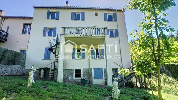 Grande maison avec jardins, terrasse et garage.