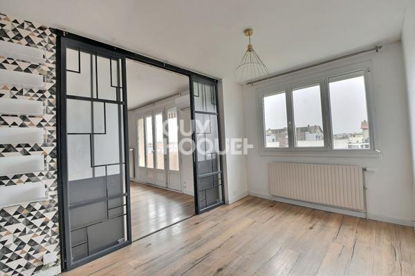 Appartement T4 de 73 m² avec balcon, parking et cave à Villeurbanne (69100).