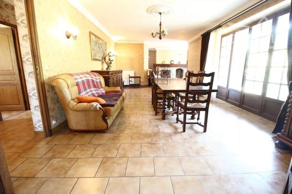 A vendre une grande maison en pierre avec un jardin clôturé, un grand garage de 132m² et une grange de 30m².