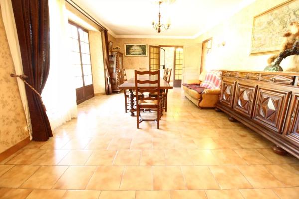 A vendre une grande maison en pierre avec un jardin clôturé, un grand garage de 132m² et une grange de 30m².