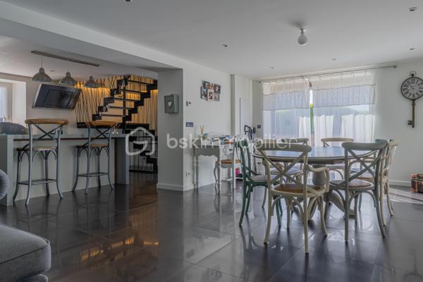 À Ferrières, dans un environnement calme et préservé, au cœur d’un cadre naturel entouré de montagnes, découvrez ce superbe duplex de 124 m², offrant un excellent compromis entre maison et appartement.

Situé dans un ancien corps de ferme, ce bien a été entièrement rénové avec goût. Il séduit par ses beaux volumes, sa circulation fluide entre les espaces et son atmosphère chaleureuse.

Au rez-de-chaussée, vous profitez d’une grande pièce de vie lumineuse de plus de 50 m², comprenant une cuisine ouverte, un espace repas et un salon. Moderne et fonctionnelle, la cuisine s’articule autour d’un îlot central convivial. Depuis la pièce de vie, vous accédez à une agréable terrasse en bois, idéale pour profiter du calme environnant. Un petit potager vient compléter ce bel extérieur.

Ce niveau dispose également d’une buanderie ainsi que d’un WC indépendant.

Un élégant escalier en métal apporte du caractère à l’ensemble et mène à l’étage. Une verrière ouvre les perspectives et renforce la luminosité de la mezzanine.

L’espace nuit se compose actuellement de deux chambres et d’une grande mezzanine, pouvant facilement être transformée en troisième chambre.

La chambre parentale, d’environ 20 m², bénéficie d’un dressing ainsi que d’une salle d’eau complète avec baignoire, douche et WC. La seconde chambre, d’environ 13 m², dispose également de sa propre douche.

Toiture et façade récentes, aucun travaux à prévoir.

Le bien fait partie d’une copropriété bénévole, sans frais de copropriété. Le chauffage est collectif avec comptage individuel, complété par un poêle à granulés apportant confort et convivialité.

Ce duplex dispose également de deux places de parking ainsi que d’une cave.

La commune de Ferrières offre un cadre naturel recherché, à proximité immédiate de la Mandallaz et à moins de 10 minutes de l’accès autoroute permettant de rejoindre Genève.

Un bien atypique et chaleureux, idéal pour ceux qui recherchent les volumes et le confort d’une maison, tout en conservant les avantages d’un appartement.