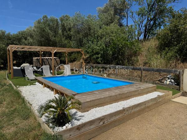 Amoureux de la pierre et des grands espaces, découvrez cette superbe maison de caractère entièrement rénovée en 2013, alliant avec élégance le charme de l'ancien et le confort moderne. Implantée sur un magnifique terrain arboré d'environ 3 225 m² agrémenté d'oliviers centenaires, elle bénéficie d'un environnement privilégié sans vis-à-vis.

Cette propriété développe environ 120 m² habitables pour environ 130 m² de surface utile. Elle dispose d'espaces complémentaires offrant une belle modularité, permettant d'envisager différentes configurations selon les projets de vie (bureau, chambre d'appoint, espace polyvalent). Dès l'entrée, vous serez séduits par son authenticité et ses prestations soignées. Le rez-de-chaussée se compose d'une belle entrée, d'un placard de rangement,   d'un WC indépendant, d'une buanderie, d'un bureau ainsi que d'une agréable pièce de vie réunissant salon, séjour et cuisine équipée ouverte. Les magnifiques murs en pierre apparente apportent un cachet unique à l'ensemble. Pour un confort optimal en toutes saisons, la maison est équipée d'une climatisation réversible ainsi que d'un poêle à granulés, offrant une solution de chauffage à la fois économique et chaleureuse.

À l'étage, un palier dessert deux chambres confortables, dont une avec dressing. Vous trouverez également un dressing indépendant, un WC séparé ainsi qu'une salle de bain équipée d'une douche, d'une baignoire et d'un meuble double vasque. Une pièce supplémentaire mansardée offre un espace complémentaire idéal pour une chambre d'appoint, un bureau, une salle de jeux ou un espace de rangement selon vos besoins.

À l'extérieur, tout a été pensé pour profiter pleinement du cadre exceptionnel. Vous disposerez d'une piscine semi-enterrée en bois d'environ 5 x 3,5 m, d'une pergola pour vos moments de détente, d'un espace en pelouse synthétique, d'un terrain de pétanque à réhabiliter selon vos envies ainsi que d'un authentique puits en pierre équipé d'une pompe. Un chemin d'accès privatif mène directement à la propriété, renforçant son caractère intimiste.

Cette maison bénéficie d'un emplacement idéal alliant tranquillité et proximité des commodités : commerces, professionnels de santé, restaurants et services du quotidien. Lézignan-Corbières est accessible en un peu plus de 10 minutes et l'accès à l'autoroute A9 en environ 8 minutes.

Une propriété pleine de charme, rare sur le secteur, qui séduira les amateurs d'authenticité, de nature et d'espace.

Contactez moi dès aujourd'hui pour organiser une visite et découvrir tout le potentiel de ce bien coup de cœur.