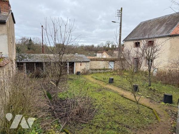 Dépendances comprenant deux garages, anciennes écuries, cave et jardin clos.