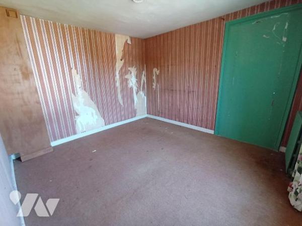 Maison de ville sans terrain à rénover, mitoyenne d'un côté et comprenant : 
- au rez-de-chaus...