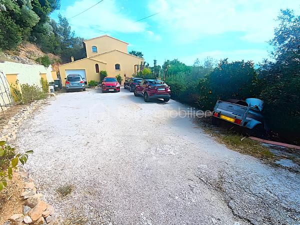 OLLIOULES – LA COURTINE

Villa avec vue panoramique, piscine à débordement et appartement indépendant

Une vue panoramique dont on ne se lasse jamais, une piscine à débordement semblant se fondre dans le paysage et un environnement préservé à quelques minutes seulement du centre d'Ollioules.

Dans l'un des secteurs résidentiels les plus recherchés de la commune, cette propriété offre un cadre de vie privilégié où intimité, lumière et panorama exceptionnel se conjuguent au quotidien.

Nichée au bout d'une impasse, à l'abri des regards, cette élégante villa construite en 2003 développe environ 225 m² habitables sur un terrain paysager de 1 662 m².

Dès les premiers instants, le charme opère.

Les volumes généreux, la luminosité omniprésente et l'ouverture permanente sur l'extérieur créent une atmosphère à la fois chaleureuse et apaisante.

Le niveau principal accueille plus de 100 m² de plain-pied baignés de lumière grâce à son exposition Sud-Sud-Ouest.

Il comprend :

• Une entrée avec dressing
• Un vaste espace de vie de près de 64 m² avec cheminée
• Une cuisine familiale entièrement équipée
• Une suite parentale avec salle d'eau privative et accès direct à la terrasse

Chaque espace profite pleinement de la vue spectaculaire qui accompagne le quotidien et prolonge naturellement les pièces de vie vers l'extérieur.

À l'étage, l'espace nuit accueille trois chambres bénéficiant chacune d'un accès direct au balcon panoramique ainsi qu'un bureau pouvant faire office de chambre supplémentaire, d'espace télétravail ou de salle de loisirs. Les autres espaces nuit se répartissent entre le niveau principal et l'appartement indépendant.

Pensée pour accueillir famille et amis dans les meilleures conditions, la propriété dispose également d'un appartement indépendant d'environ 54 m² avec terrasse privative.

Véritable atout de la propriété, cet espace complémentaire permet de recevoir en toute intimité, d'exercer une activité professionnelle indépendante ou d'envisager un revenu locatif.

À l'extérieur, le spectacle continue.

La piscine à débordement de 9 x 4 mètres semble se fondre dans le paysage et offre un point de vue privilégié sur les collines du littoral varois.

Les terrasses, espaces détente et coins repas invitent à profiter pleinement du climat méditerranéen et des couchers de soleil qui rythment les saisons.

Deux vastes restanques supplémentaires offrent encore de nombreuses possibilités d'aménagement selon vos envies : jardin méditerranéen, terrain de pétanque, espace de loisirs ou projet paysager personnalisé.

Les prestations :

• Environ 225 m² habitables
• Terrain de 1 662 m²
• Construction de 2003
• 5 chambres + 1 bureau
• 3 salles d'eau dont une à personnaliser
• Appartement indépendant de 54 m²
• Piscine à débordement 9 x 4 m
• Pompe à chaleur récente (2024)
• Climatisation réversible
• Double vitrage
• Garage de 20 m²
• Nombreuses places de stationnement
• Portail automatique

À seulement quelques minutes du centre historique d'Ollioules, des commerces, des écoles et des principaux axes de communication, cette propriété conjugue parfaitement tranquillité, confort et proximité.

Les propriétés offrant une telle combinaison de vue panoramique, d'intimité, d'espaces extérieurs, de potentiel d'accueil et de proximité avec le centre d'Ollioules sont particulièrement rares sur le secteur.

Ici, les saisons défilent, la lumière évolue au fil des heures et le panorama reste toujours aussi spectaculaire.

Visite exclusivement sur rendez-vous.

Kévin LEXA
BSK Immobilier
Disponible 7J/7
