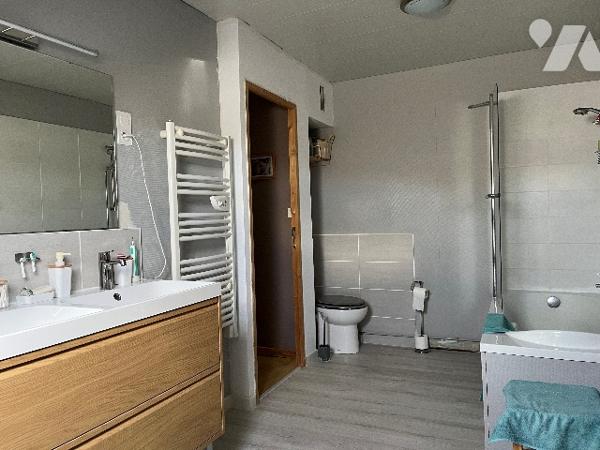 Maison d'habitation comprenant : salon-séjour, cuisine, 2 chambres, salle de bains, véranda, garage.