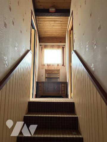 Sur environ 5300 m² de terrain, une agréable maison offrant 5 chambres, une véranda, deux garages 