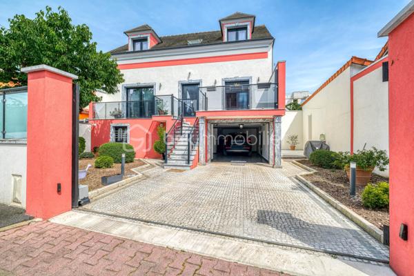 Élevée et baignée de lumière, cette maison de 124 m² de surface habitable, offrant 175 m² de surface utile au total avec buanderie et garage, récente offre une vraie vie de famille chic et pratique, à deux pas des commodités de Champigny.

Les atouts qui font la différence

Entrée majestueuse: on gravit quelques marches et l’on découvre un grand séjour traversant, chaleureux, ouvert sur la terrasse surélevée – parfait pour recevoir.
Cuisine esprit « family room »: moderne, entièrement équipée, conviviale autour de la table centrale.
Salon cocooning avec cheminée: belles soirées assurées hiver comme été.

Rez‑de‑jardin polyvalent

- Chambre indépendante parfaite pour télétravail, ado ou invités.
- Couloir avec rangements intégrés très pratiques.
-  Salle d’eau avec douche et WC.
- Buanderie attenante.
- Grand garage motorisé + portail électrique, borne de recharge pour véhicule électrique.

Étage nuit

- Deux chambres confortables avec rangements, traversantes, équipées de Velux et volets roulants électriques pour une lumière maîtrisée et un confort optimal.
- Spacieuse salle de bains: baignoire, douche, double vasque.
- WC séparés.

Confort et équipements

- Jardin paysager, impeccablement entretenu, sans vis‑à‑vis: véritable prolongement du séjour pour des réceptions élégantes.
 - Espace latéral prêt à vivre (eau + électricité): parfait pour imaginer une cuisine d’été raffinée, un jacuzzi ou un lounge extérieur.
- Fermetures premium: volets roulants électriques sur baies et Velux, double vitrage performant, éclairages encastrés.
- Stationnement d’exception: double garage fermé avec porte motorisée, portail d’entrée électrique pour un accès fluide et sécurisé.
- Mobilité de demain: borne de recharge pour véhicule électrique intégrée.
- Praticité quotidienne: buanderie dédiée, rangements généreux, matériaux choisis pour leur durabilité et leur facilité d’entretien.
- Chauffage performant: chaudière gaz à condensation Frisquet avec plancher chauffant, complétée par un insert bois pour l’appoint; production d’eau chaude couplée à la chaudière.

 Dans un secteur résidentiel recherché, cette maison clé en main marie style, confort et prestations haut de gamme, dedans comme dehors. 
Dossier complet (plans, surfaces, diagnostics) et visites privées sur rendez‑vous. Un bien rare, à découvrir sans tarder.