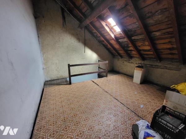 Maison mitoyenne cinq pièces avec cave et garage sur 3a 08ca de terrain