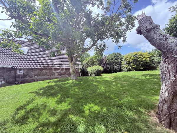 Située à Esson, à 3 min de la dynamique ville de Thury-Harcourt, en plein coeur de la Suisse Normande, cette maison ancienne séduira les amoureux de la pierre et de l'authenticité. Développant 108m2 habitables et environ 130m2 au sol, elle est idéale pour une vie de famille. 

En rez-de-chaussée, vous trouverez une grande cuisine dinatoire de 21m2 environ et une pièce à vivre avec cheminée de plus de 30m2. Les ouvertures côté Sud confèrent à ces deux pièces une belle luminosité. 
Au niveau 1, en rez-de-jardin, un couloir parqueté dessert une grande chambre très lumineuse équipée de placards intégrés, rénovée avec goût et pleine de cachet, une salle de bain avec baignoire et buanderie, des WC indépendants. A ce niveau, une porte vous permet d'accéder au jardin situé derrière la maison et à une terrasse couverte. 
Par un demi-palier, vous accéderez à une deuxième grande chambre de plus de 14m2 habitables . 
Au dernier niveau, sous combles, une très jolie chambre pleine de charme, offrant une magnifique vue sur la campagne et bientôt dotée de sa propre salle d'eau avec WC !! 
Vous l'aurez compris, cette maison allie à merveille le charme de l'ancien et les équipements modernes ; les panneaux photovoltaïques et le chauffe-eau thermodynamique garantissent une économie d'énergie significative. Les menuiseries en PVC double vitrage à isolation renforcée ainsi que les volets roulants offrent, quant à eux, un confort moderne à cette maison. 

A l'extérieur, plusieurs parcelles permettent de laisser libre court à vos futurs projets. En effet, derrière la maison, sans aucun vis à vis, vous jouirez d'un jardin d'environ 400m2 avec grand abris de jardin sur dalle  béton . En face de la maison, plusieurs parcelles pour une contenance totale de 541m2. 

Les atouts de ce bien : 
- Cachet et charme de l'ancien 
- Equipements ( chauffe-eau thermodynamique, panneaux solaires, menuiseries PVC, volets roulants)
- A quelques minutes des commerces et écoles , 25 min de Caen 
- Suite parentale au niveau 2 
- Au calme, en impasse 

Quelques travaux de finitions et d'embellissement de la façade sont à prévoir pour redonner tout son cachet à cette jolie maison du XIXème, nous vous proposons quelques suggestions afin de mieux vous projeter.
