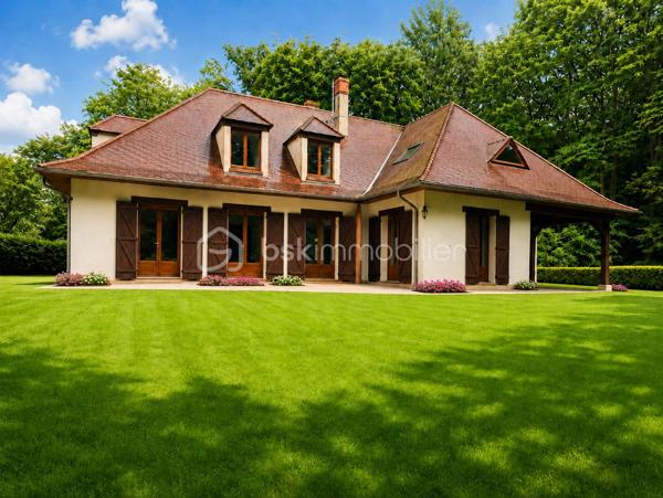 Demeure de charme de 12 pièces d’environ 344 m² habitables sur sous-sol total de 241 m²– Grand terrain boisé DE 7 300 m², calme absolu, sans vis-à-vis, 9 chambres, deux salles d'eau, une salle de bain, quatre WC séparés, avec près de 585 m² de potentiel global entre habitation et dépendances.

Au cœur d’un environnement rare, paisible et verdoyant, venez découvrir cette superbe propriété de charme, nichée dans un écrin de nature d’environ 7 300 m². Ici, tout invite à la sérénité : le calme, les arbres, l’espace, l’absence de vis-à-vis et cette impression immédiate d’être dans un lieu privilégié, à l’abri du bruit et du regard.

Dès l’arrivée, la maison séduit par son allure élégante, son architecture chaleureuse et ses très beaux volumes. Avec environ 344 m² habitables, elle offre un confort de vie remarquable, pensé pour une grande famille, pour recevoir, pour télétravailler, ou encore pour imaginer un projet de résidence secondaire, familiale ou de maison d’hôtes.

Le rez-de-chaussée développe à lui seul près de 200 m² et s’articule autour d’une pièce de vie spectaculaire d’environ 170 m². Ce vaste espace, à la fois lumineux, convivial et impressionnant par ses volumes, constitue le véritable cœur de la maison. Le hall et la pièce de réception créent immédiatement une atmosphère unique : on s’y projette naturellement pour partager de grands repas, recevoir des amis, profiter de moments en famille ou simplement savourer le calme de la propriété.

La maison dispose également d’une cuisine fonctionnelle, de plusieurs chambres au rez-de-chaussée, de salles d’eau, de rangements et d’espaces de dégagement généreux. Les ouvertures sur l’extérieur permettent de profiter pleinement du jardin, des terrasses et de la nature environnante.

À l’étage, l’espace continue de surprendre par ses volumes. Environ 145 m² habitables viennent compléter la maison, avec une grande pièce salon-bibliothèque d’environ 48 m², idéale pour créer un second salon, une salle de jeux, un espace lecture, un bureau de caractère ou un lieu de détente indépendant. Plusieurs chambres supplémentaires permettent d’accueillir famille, enfants, invités ou d’aménager des espaces selon les besoins de chacun.

Cette propriété offre une vraie liberté d’usage : chacun peut y trouver sa place, sans jamais se sentir à l’étroit. Les volumes sont rares, l’organisation est fluide, et la maison dégage une atmosphère à la fois familiale, élégante et chaleureuse.

Côté annexes, le bien dispose d’un sous-sol d’environ 187 m², offrant de nombreuses possibilités : garage, stockage, atelier, cave, espace technique ou rangement complémentaire. Un grand préau d’environ 54 m² permet également de stationner plusieurs véhicules à l’abri, avec une capacité confortable de deux à quatre voitures selon l’organisation souhaitée. Au total, les dépendances représentent environ 241 m², portant l’ensemble habitable et annexes à environ 585 m².

À l’extérieur, le terrain boisé d’environ 7 300 m² constitue l’un des grands atouts de cette propriété. Le cadre est superbe, verdoyant, intime, sans vis-à-vis, avec une vraie sensation d’espace et de tranquillité. C’est un lieu où l’on respire, où l’on entend la nature, où l’on peut imaginer des moments simples et précieux : petits-déjeuners en terrasse, soirées d’été, jeux d’enfants, promenades dans le jardin, ou simplement le plaisir de profiter d’un environnement exceptionnel au quotidien.

Cette demeure s’adresse à des acquéreurs en recherche d’un bien différent, avec une âme, de l’espace, du charme et un cadre de vie privilégié. Une maison qui ne se résume pas à des mètres carrés, mais à une véritable sensation de bien-être dès les premiers instants.

Un bien rare, généreux, lumineux, fonctionnel et plein de potentiel, à découvrir absolument pour en apprécier toute la force et l’atmosphère.

Pour tout renseignement complémentaire ou pour organiser une visite, je reste à votre disposition. Une visite permettra de ressentir pleinement le charme, le calme et le caractère exceptionnel de cette propriété