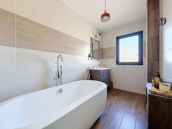 Installée sur une belle parcelle close de 930 m², cette jolie construction de 2017 combine les lignes épurées d'aujourd'hui et le confort d'un intérieur particulièrement soigné. Très économe au quotidien (classée A), elle offre un cadre de vie aussi doux pour le budget que pour l'esprit.

Dès l'entrée, l'ambiance est donnée. Le regard se tourne naturellement vers la pièce maîtresse : un espace de vie de 45 m² très lumineux, où le salon, le séjour et la cuisine équipée se partagent l'espace en toute convivialité. Ce rez-de-chaussée a été pensé pour vous simplifier la vie grâce à un véritable aménagement de plain-pied : vous y trouverez une chambre, une salle de bains complète (baignoire et douche) ainsi qu'un WC séparé. Une buanderie très pratique fait le lien direct avec le garage.

A l'étage, vous découvrez une mezzanine agréable qui peut devenir votre coin de lecture. Les enfants disposeront de deux chambres tandis que les parents s'approprieront une véritable suite avec dressing et salle d'eau privative. Le vrai luxe de cette chambre : Une baie vitrée qui s'ouvre sur une terrasse suspendue, parfaite pour les premiers cafés du matin !

Côté jardin
Profitez d'une grande terrasse face à un terrain arboré de plusieurs arbres fruitiers. Entièrement clos et équipé d'un portail en aluminium électrique, le jardin devient un terrain de jeu sécurisé pour toute la famille.

Les points forts à retenir :

Construction de 2017 avec d'excellentes performances énergétiques (Classe A).

Configuration de plain-pied au rez-de-chaussée.

4 chambres au total, dont une suite parentale avec sa terrasse perchée !

Extérieur clos, arboré et intimiste.