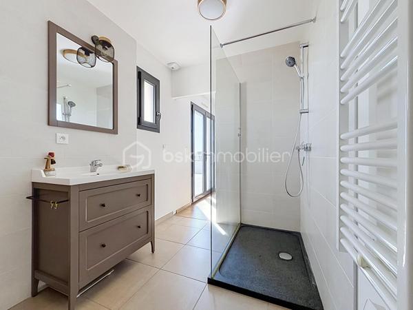 Installée sur une belle parcelle close de 930 m², cette jolie construction de 2017 combine les lignes épurées d'aujourd'hui et le confort d'un intérieur particulièrement soigné. Très économe au quotidien (classée A), elle offre un cadre de vie aussi doux pour le budget que pour l'esprit.

Dès l'entrée, l'ambiance est donnée. Le regard se tourne naturellement vers la pièce maîtresse : un espace de vie de 45 m² très lumineux, où le salon, le séjour et la cuisine équipée se partagent l'espace en toute convivialité. Ce rez-de-chaussée a été pensé pour vous simplifier la vie grâce à un véritable aménagement de plain-pied : vous y trouverez une chambre, une salle de bains complète (baignoire et douche) ainsi qu'un WC séparé. Une buanderie très pratique fait le lien direct avec le garage.

A l'étage, vous découvrez une mezzanine agréable qui peut devenir votre coin de lecture. Les enfants disposeront de deux chambres tandis que les parents s'approprieront une véritable suite avec dressing et salle d'eau privative. Le vrai luxe de cette chambre : Une baie vitrée qui s'ouvre sur une terrasse suspendue, parfaite pour les premiers cafés du matin !

Côté jardin
Profitez d'une grande terrasse face à un terrain arboré de plusieurs arbres fruitiers. Entièrement clos et équipé d'un portail en aluminium électrique, le jardin devient un terrain de jeu sécurisé pour toute la famille.

Les points forts à retenir :

Construction de 2017 avec d'excellentes performances énergétiques (Classe A).

Configuration de plain-pied au rez-de-chaussée.

4 chambres au total, dont une suite parentale avec sa terrasse perchée !

Extérieur clos, arboré et intimiste.