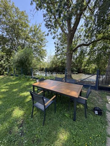 Implantée dans Gisors, à cinq minutes des commerces, des établissements scolaires et de la gare, cette maison familiale de 135 m² bénéficie d'une situation rare : un terrain clos de 602 m² en bordure directe de l'Epte, avec une vue sur la rivière et un cadre verdoyant calme et préservé.

Rez-de-chaussée : L'entrée ouvre sur un séjour lumineux prolongé par un balcon avec vue directe sur le jardin — une continuité intérieur-extérieur particulièrement agréable aux beaux jours. La cuisine, aménagée et équipée, complète l'espace de vie. Deux chambres, une salle d'eau et un WC indépendant avec lave-mains complètent ce niveau, permettant d'envisager une organisation de plain-pied si nécessaire.

À l'étage : L'étage accueille deux chambres supplémentaires, une salle de bains et un WC indépendant. Il comprend également un espace modulable à aménager selon les besoins : bureau, chambre d'amis, salle de jeux ou espace de rangement. La maison compte ainsi quatre chambres au total, bien réparties entre les deux niveaux de vie.

Sous-sol total : Le sous-sol entièrement aménagé constitue l'un des atouts majeurs du bien. Il comprend un garage, une buanderie, une cave et un atelier. S'y ajoute un bureau chauffé, séparé des pièces de vie et parfaitement configuré pour le télétravail : un espace silencieux, fonctionnel et autonome.

Extérieur : Le terrain clos de 602 m², en bordure de l'Epte, offre un espace extérieur généreux, verdoyant et préservé. Le balcon au rez-de-chaussée prolonge naturellement l'intérieur vers le jardin. Un cadre calme, adapté à la vie en famille comme aux moments de détente en plein air.

Environnement et accès : Gisors, sous-préfecture de l'Eure (27), réunit commerces, écoles et gare en centre-ville, l'ensemble accessible en cinq minutes depuis la maison. La commune bénéficie par ailleurs de la proximité de l'Île-de-France, ce qui en fait un point d'ancrage apprécié des actifs souhaitant conjuguer cadre normand et connexions vers Paris.

Maison familiale lumineuse en bordure de l'Epte, avec sous-sol total et bureau chauffé — à cinq minutes du cœur de Gisors.