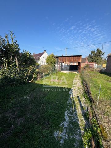 LA NEUVILLE TERRAIN VIABILISE AVEC GRAND CARPORT