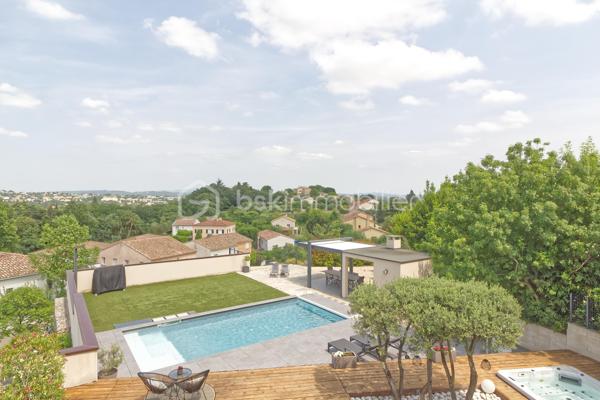 Niché sur les hauteurs d’Alès, le bien bénéficie d’une situation et d’un cadre de vie privilégié tout en profitant d’une vue panoramique exceptionnelle.
Cette villa contemporaine de 165 m², pensée et conçue pour un confort optimal allie le mariage parfait entre design moderne et prestations haut de gamme.
L’accès à la villa se réalise par un superbe escalier extérieur en pierres de Bourgogne.
L’intérieur de la maison offre une cuisine ouverte sur une pièce de vie de belle dimension s’ouvrant sur une magnifique terrasse.
Les baies vitrées panoramiques permettent à la lumière naturelle d’être présente créant ainsi une atmosphère chaleureuse.
Le rez-de-chaussée offre également trois chambres, une salle de bain et une buanderie.
L’étage accueille un espace parental de 40 m² avec une salle d’eau disposant en plus d’une baignoire, créant un véritable espace de détente, une chambre et son dressing avec sa petite terrasse privative et son sublime panorama.
A l’extérieur, vous disposerez d’un espace à vivre d’environ 450 m² et sa généreuse terrasse, son jacuzzi, sa piscine avec sa plage et sa cuisine d’été pourvue d’une pergola Bio climatique.
Des panneaux photovoltaïques pour des économies d'énergie, un grand garage, une alarme (avec abonnement) complètent le bien.
Charme, simplicité et cohérence font de ce bien un véritable petit paradis 
Alliant sérénité et convivialité, il est idéal pour une famille ou un couple aimant recevoir.
Votre conseiller immobilier sur le bassin alésien, Lionel Rodier O6.81.447.157, l.rodier@bskimmobilier.com