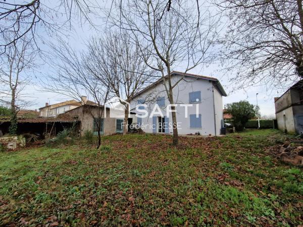 Maison T6 125m² avec garages et jardin de 2200m².