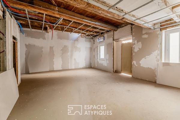 Appartement rez-de-jardin avec patio privé et garage au centre-ville