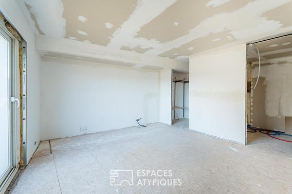 Appartement rez-de-jardin avec patio privé et garage au centre-ville