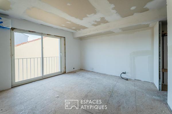 Appartement rez-de-jardin avec patio privé et garage au centre-ville