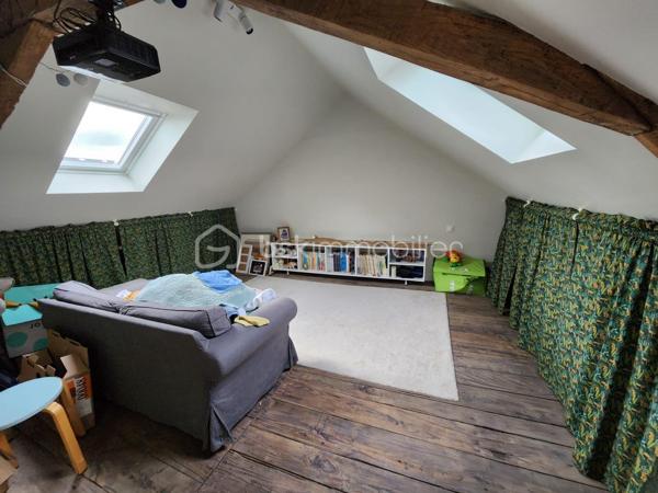 Rare à la vente, cette maison de ville rénovée de 144m2 située dans l'hypercentre du Bourgneuf-la-Forêt a de nombreux atouts pour séduire ses futurs propriétaires. 
Si vous aimez les maisons avec du charme, du cachet , les belles hauteurs sous plafond, cette maison est peut-être votre futur nid douillet. 
Nous commencerons la visite par une entrée qui traditionnellement distribue d'un coté la cuisine spacieuse de 23m2 équipée et aménagée et de l'autre coté le salon séjour de 27m2. 
Nous monterons l'escalier pour découvrir une première chambre de 11m2, une seconde de 9m2, une salle de bain de 5m2, un wc séparé de 2m2 environ et... une suite parentale de 26m2 environ comprenant une chambre de 15m2, un dressing de 7m2 et une salle d'eau de 4m2 ! 
Nous poursuivrons avec le 2ème étage, un palier de 6m2 dessert une quatrième chambre de 22m2 au sol et une cinquième de 25m2 au sol ! De beaux espaces vous permettant d'accueillir famille et amis en toute sérénité. 
Toutes les menuiseries sont en double vitrage. Toute l'isolation périphérique de la maison a été refaite, l'isolation des combles, mais aussi l'ensemble des sols et des peintures. Les volets de la façade avant et les velux ont également été changés en 2019, les gouttières ont été remplacées par des gouttières en zinc en 2020, les cache-moineaux ont été refaits aussi ainsi que la façade sud, en pierre, en 2022. La toiture est en ardoises naturelles. Le mode de chauffage principale est une pompe à chaleur installée en 2019 et en complément vous pourrez utiliser l'insert bois. La taxe foncière est de 570€. 
Coté stockage, un garage semi-ouvert se situe à l'avant de la maison, dans la cour privative. Il fait 20m2, idéal pour y stationner votre voiture. 
Pour le reste de vos objets personnels à stocker, une cave isolée complète l'équipement de la maison. 
Coté extérieur, vous pourrez profiter en toute tranquillité de la parcelle entièrement close de 625m2 environ. 
Alors cette maison correspond à votre critère de recherches ? Ne tardez pas, appelez-moi !