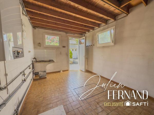 Maison à étage avec garage, véranda et jardin.