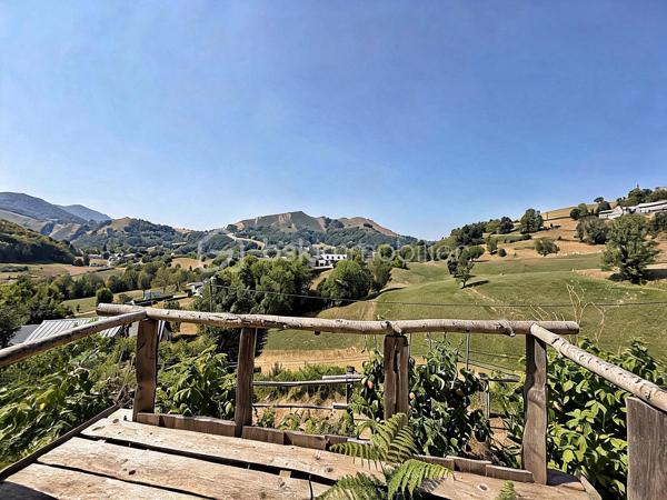 En exclusivité, à seulement 30 minutes de Bagnères-de-Bigorre, au cœur des Baronnies, découvrez cette propriété pleine de charme, nichée dans un environnement privilégié, au calme absolu, avec une vue exceptionnelle sur la nature environnante. Véritable havre de paix, cet ensemble immobilier séduit par son authenticité, son potentiel et son cadre de vie unique, idéal pour les amoureux de nature, de sérénité et de projets de vie inspirants.

La propriété se compose d’une maison principale chaleureuse et accueillante, ainsi que d’une seconde bâtisse offrant de multiples possibilités d’usage. 

La maison principale propose, au rez-de-chaussée, une grande cuisine équipée, pleine de charme et d’authenticité, où il fait bon partager les repas, un salon-séjour convivial, une salle d’eau rénovée avec goût ainsi qu’un WC séparé. À l’étage, un palier avec rangements dessert deux belles chambres lumineuses, elles aussi équipées de rangements, offrant confort et fonctionnalité au quotidien.

La seconde bâtisse complète harmonieusement l’ensemble avec un grand garage, un atelier avec rangements, une terrasse couverte aménagée en véritable espace de vie avec coin repas et ventilateur, ainsi qu’un studio cocooning disposant d’une kitchenette, d’une salle de douche et de toilettes sèches. Cet espace indépendant ouvre la voie à de nombreux projets : accueil d’amis ou de famille, location saisonnière, activité Airbnb, espace de travail ou atelier créatif.

À l’extérieur, le terrain arboré de 8 300 m² constitue un atout majeur. Déjà aménagé avec soin, il accueille une serre, des potagers, des vergers, un poulailler ainsi qu’un petit chalet avec terrasse, dans une atmosphère naturelle et inspirante. Ici, tout invite à imaginer un mode de vie plus autonome, plus doux, plus proche de la nature. Le bien offre également un joli potentiel de développement, notamment pour un projet d’hébergement touristique avec plusieurs petits chalets, ou pour une vie tournée vers l’autosuffisance.

Le confort est assuré par un chauffage électrique complété par un poêle à bois, pour une ambiance chaleureuse en toute saison. Ce bien rare séduira autant les acquéreurs en quête d’une résidence principale de caractère que les porteurs de projet recherchant un lieu à fort potentiel dans un cadre préservé.

Un bien atypique, authentique et inspirant, à découvrir sans tarder.