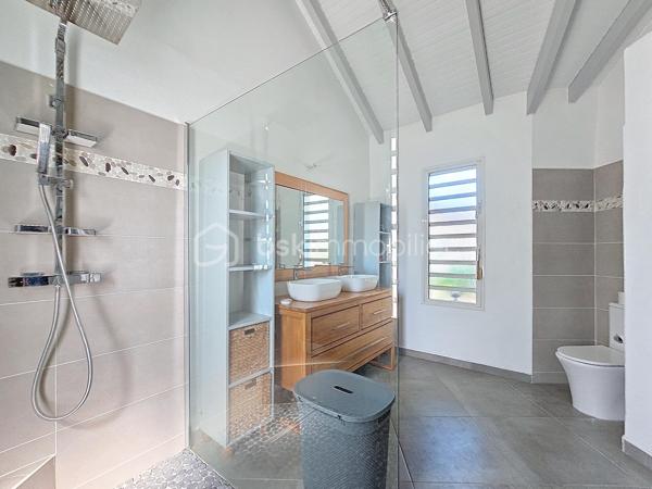 Coup de coeur assuré pour cette villa contemporaine offrant de beaux volumes d'une surface habitable de 119 m2 (surface utile 160 m2)
édifiée de plain-pied sur une parcelle de 1543 m2.
A seulement 5 minutes des commodités du centre-ville et de la plage des Raisins Clairs, au calme elle bénéficie d'un environnement idéal.
De construction atypique, elle se compose de 3 modules
- le premier est un espace pièce à vivre de 40 m2 avec son grand salon et sa cuisine ouverte équipée moderne , un toilette invité, un cellier
extérieur.
- Empruntez le patio et vous accédez au second module offrant deux grandes suites parentales climatisées avec douche à l'italienne, dressing
et toilettes.
- Enfin, le troisième espace bénéficiant d'une vue directe avec ses baies vitrées sur la piscine est une troisième suite parentale climatisée
avec son dressing, sa salle d'eau douche à l'italienne et toilettes.
Vous profiterez également d'une grande terrasse et sa piscine au sel de dimension 4x4 (achevée il y a un an) avec son liner pierres de Bali.
La villa sera cédée avec son mobilier vous n'avez plus qu'à poser vos valises!
Ses équipements : citerne tampon 3300 litres , fibre optique, carport pouvant abriter 2 véhicules et assainissement individuel avec conformité.
Atout supplémentaire: la bonne implantation de la villa sur la parcelle laisse place à une bande de terrain restante laissant un potentiel de
construction additionnel (située en zone u4 du PLU) comme des bungalows ...
Etiquette énergétique: classe B
Vous l'avez compris cette villa est un petit bijou avec encore un potentiel restant, alors n'hésitez pas à me contacter pour de plus amples
informations, accéder au reportage photos complet ou à la vidéo!
Pour le réseau BSK Immobilier : Delphine MIRANDA (EI)
Honoraires charge vendeur
