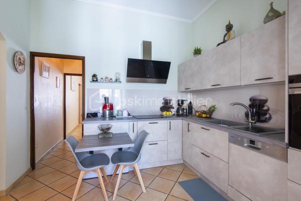 Belle maison de caractère située en centre-ville de Miramas, dans les Bouches-du-Rhône. Avec ses 150 m² habitables répartis sur deux niveaux, elle offre de beaux volumes et un cadre de vie agréable, idéal pour une famille.

Au rez-de-chaussée, vous découvrez une entrée, un vaste salon, une salle à manger, une cuisine indépendante, une buanderie et un WC. Les hauteurs sous plafond généreuses — plus de 3 mètres — apportent une vraie sensation d'espace et de luminosité. La configuration du rez-de-chaussée offre également la possibilité de créer une chambre supplémentaire sans aucun travaux, un vrai plus pour les familles.

À l'étage, la maison propose 4 chambres avec leurs placards, une salle d'eau et un palier spacieux.

La maison bénéficie également d'annexes très appréciables : une véranda de 34 m², une buanderie, deux caves en sous-sol.

Côté équipements, le bien est chauffé et climatisé par une pompe à chaleur air/air, et dispose de panneaux photovoltaïques. Les menuiseries sont en double vitrage.