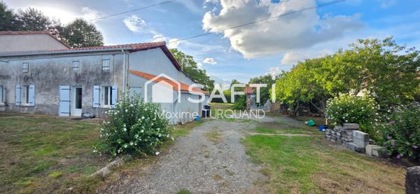 Ensemble immobilier comprenant 2 logements dont 1 loué + terrains + dépendances.