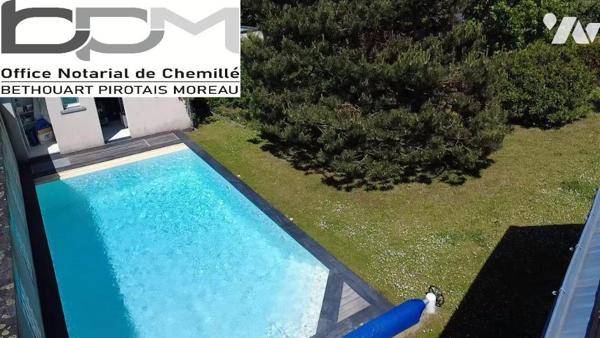 A Mûrs-Érigné, cette propriété de caractère et de charme, clos de murs, offre un cadre de vie e...