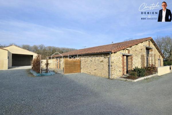 Christophe DEBIEN – BSK Immobilier – vous présente en exclusivité cette propriété de caractère située au pied de la forêt de Sainte-Florence.

Dans un environnement préservé, à l’abri des regards et entourée de nature, cette authentique grange en pierre entièrement rénovée développe 231 m² habitables sur un terrain paysagé de 1 890 m².

Un bien rare où le charme de l’ancien se conjugue parfaitement avec des prestations modernes et des volumes généreux.

Dès l’entrée, la maison séduit par son atmosphère chaleureuse et ses espaces lumineux. Le salon cathédrale de 42 m², agrémenté d’un poêle à bois et d’une mezzanine ouverte, crée un véritable lieu de vie convivial et élégant.

La maison offre une organisation idéale pour une vie familiale, une activité indépendante ou un projet d’accueil :
• Une vaste pièce de vie de 47 m² avec cuisine aménagée et équipée, ouverte sur la terrasse et le patio
• Une suite parentale de plain-pied avec dressing, salle d’eau, WC et terrasse privative
• Une lingerie et des toilettes indépendantes
• Un espace indépendant comprenant un séjour, trois chambres, une salle d’eau à terminer ainsi que des toilettes, pouvant convenir à la famille, aux amis ou à un projet de gîte
• Un garage de 48 m² avec grenier aménagé
• Une cave ainsi qu’un garage non attenant avec abri bois
• Trois terrasses orientées sur le jardin et la forêt

Les prestations apportent un confort de vie recherché :
• Chauffage au sol par pompe à chaleur air/eau
• Ventilation double flux
• Aspiration centralisée
• Menuiseries double vitrage
• Volets roulants électriques

L’emplacement constitue également un véritable atout :
• Échangeur A83/A87 à moins de 5 minutes
• Nantes à 50 minutes
• Cholet à 35 minutes
• Les Sables-d’Olonne à 45 minutes

Cette propriété s’adresse aux acquéreurs en quête d’un lieu de vie authentique, paisible et fonctionnel, sans compromis sur l’accessibilité.

Une visite permettra d’en apprécier pleinement les volumes, l’environnement et le potentiel.

Contactez-moi dès maintenant pour organiser votre découverte de ce bien exclusif.

Visite virtuelle disponible sur demande.

Conformément à la loi ELAN, tout candidat acquéreur peut se faire accompagner lors de la visite par le professionnel du bâtiment de son choix, sous réserve d’en informer préalablement l’agence afin d’organiser la visite dans les meilleures conditions.