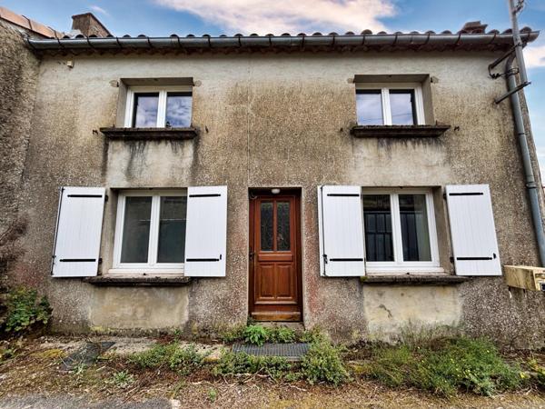 Maison à rénover avec garage, terrasse et parcelle de terrain.