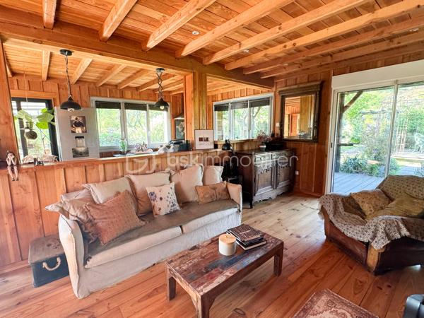Rare à la vente, cet atelier d'artiste aménagé en maison d'habitation offre un beau potentiel à ses futurs propriétaires. 
Amoureux du bois et de la nature, ce "chalet" est fait pour vous ! Contrairement à ce que l'on pourrait penser, la structure de la maison n'est pas en bois mais en parpaing et a été enduite à la chaux. Ensuite un bardage bois a été posé. 
S'il reste aujourd'hui un atelier de peinture de 28m2 dans lequel vous pourriez aisément aussi y faire un bureau, une salle de sport, une salle de jeux ou un garage, 105m2 sont prêts à accueillir votre famille. 
Nous commencerons la visite par la pièce de vie de 45m2 qui comprend le salon-séjour et la cuisine. Une magnifique véranda chauffée "jardin d'hiver" complète cette maison, idéale pour y installer une grande table familiale ou encore un salon. 
Nous poursuivrons la visite du rez-de-chaussée avec une salle d'eau de 6m2, une chambre de 11m2. 
A l'étage, deux chambres de 12m2 au sol dont une donne accès à la "tour". 
Le mode de chauffage principal est un poêle à bois et radiateurs électriques dans la véranda et l'atelier. La maison consomme peu, le DPE est en C. 
Toutes les menuiseries sont en double vitrage. 
Coté rangement, belle surprise avec le sous-sol de 75m2, vous pourrez y stocker vélos, motos, outils et aisément un coin bricolage si vous le souhaitez. Pas de voiture possible. 
Une microstation a été installée. La toiture est en bac acier. 
Coté extérieur, vous pourrez profitez sans aucun vis à vis de la parcelle de 3300m2 partiellement close et joliment arborée et agrémentée tant par ses terrasses bois que par le bassin à poissons avec sa fontaine. 
Vous aimez le jardin, deux serres sont en place. 
La maison se situe aux portes de la Bretagne, à deux minutes de l'axe Laval-Rennes. 
Alors vous aussi vous aimez cette maison-atelier ? Appelez-moi pour plus de renseignements et peut-être fixer une visite !